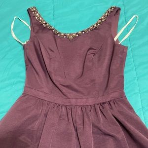 Plum colored dress with silver beads. Cut out back and pockets.
